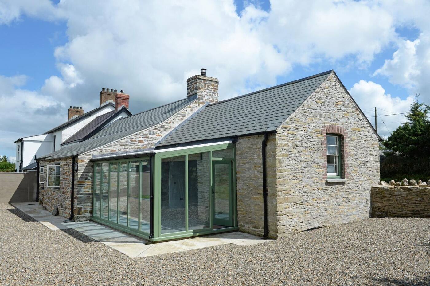 Stone cottage with a new timber garden room made by Thomas Joinery at Maengwyn, Efailwen