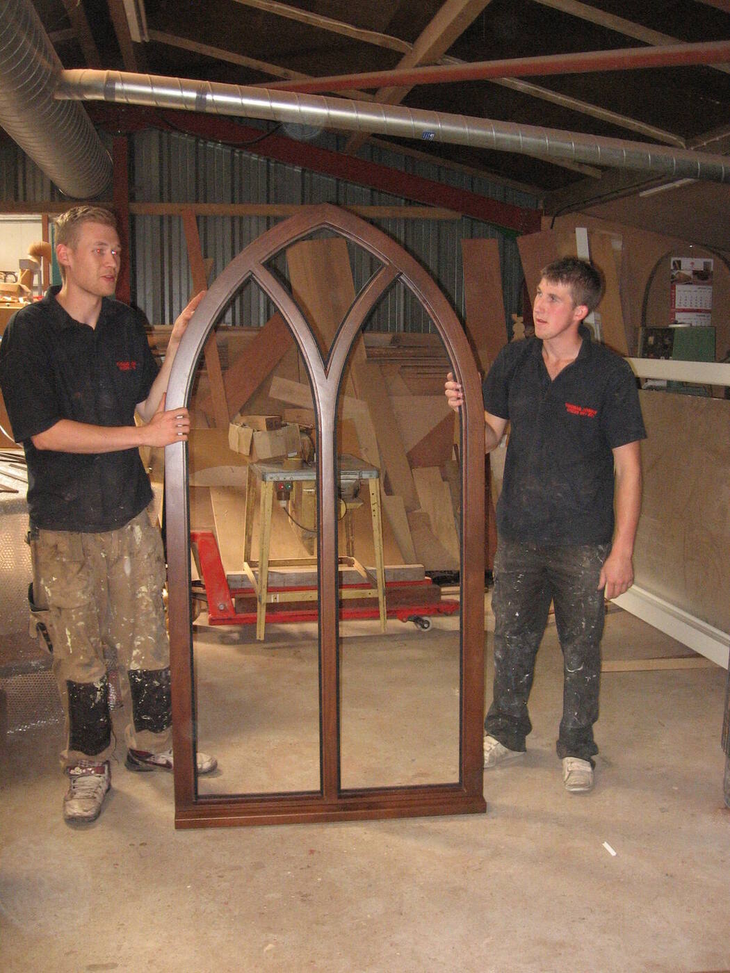 Thomas Joinery craftsmen with a gothic arched window frame in the workshop